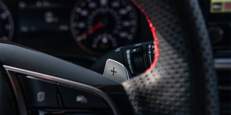 view of a Kia speedometer behind the wheel